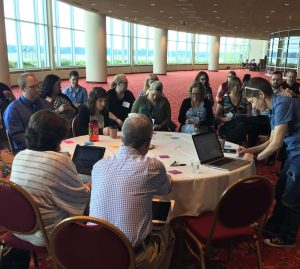 A table with conference participants writing down their fears on post-it notes.